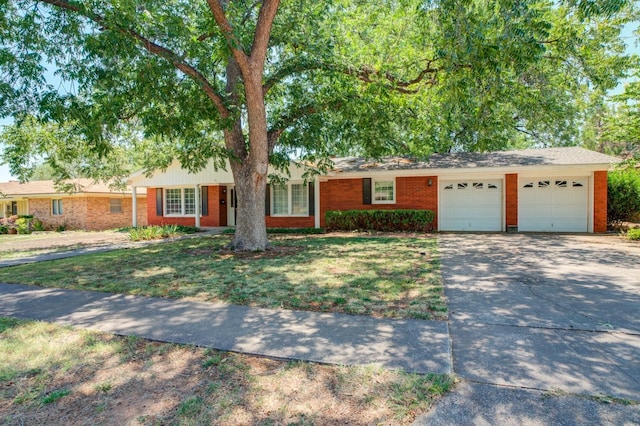 single story home with a garage and a front yard