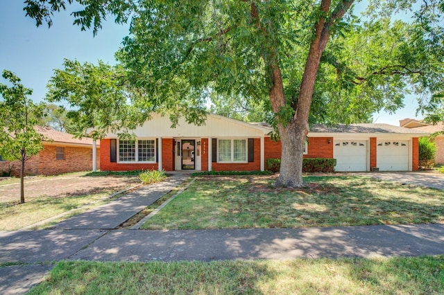 single story home with a garage and a front lawn