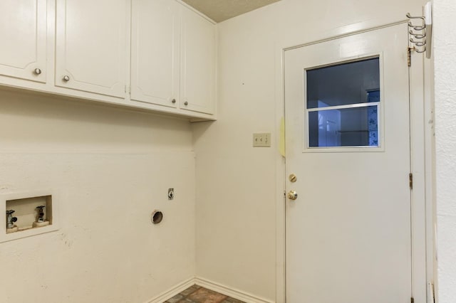 clothes washing area with cabinets, hookup for a washing machine, and hookup for an electric dryer