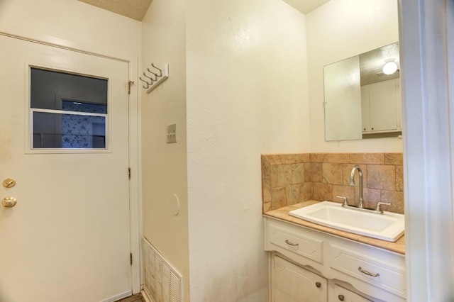 bathroom featuring tasteful backsplash and vanity