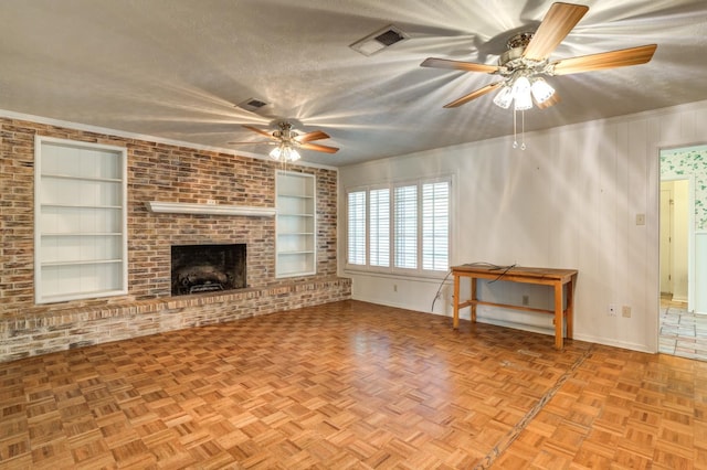 unfurnished living room featuring light parquet flooring, a brick fireplace, built in features, and a textured ceiling