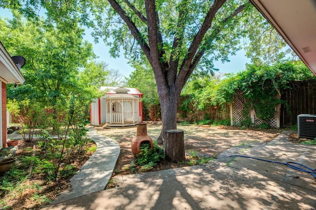 view of yard featuring central AC and a patio area