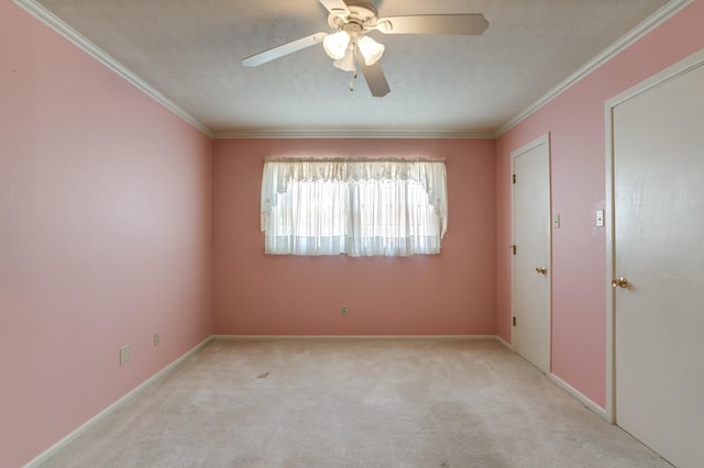 unfurnished room with crown molding, light colored carpet, ceiling fan, and a textured ceiling