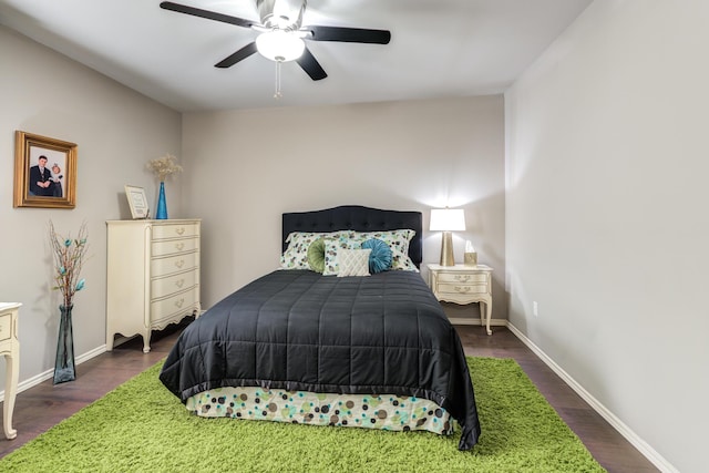 bedroom with ceiling fan and dark hardwood / wood-style floors