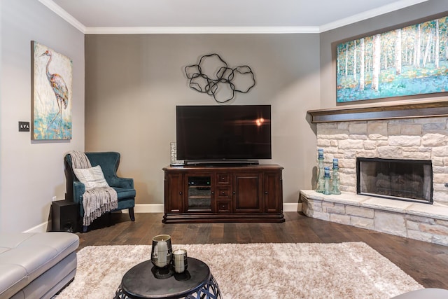 living room with crown molding, a fireplace, and dark hardwood / wood-style flooring