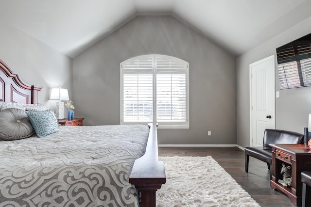 bedroom featuring dark hardwood / wood-style flooring and vaulted ceiling