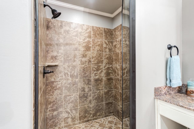 bathroom with vanity, a shower with door, and ornamental molding