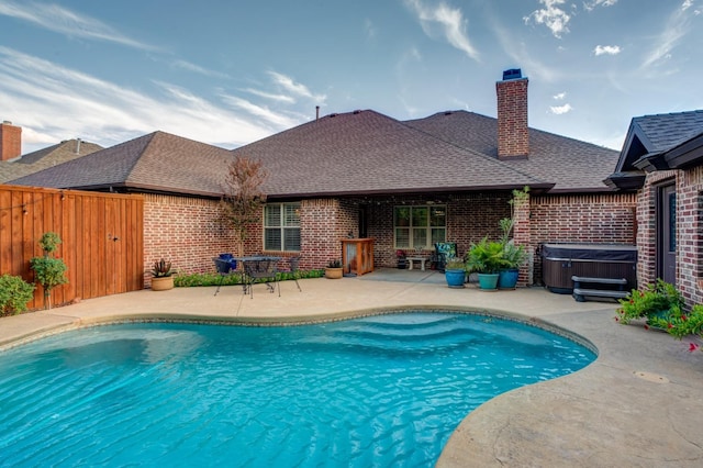 view of pool featuring a hot tub and a patio