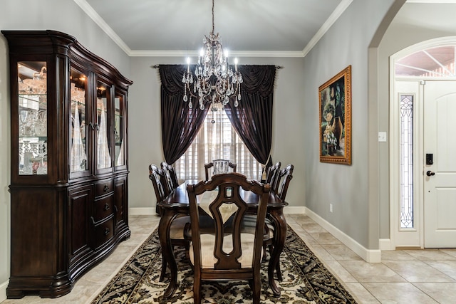 tiled dining space featuring crown molding and an inviting chandelier