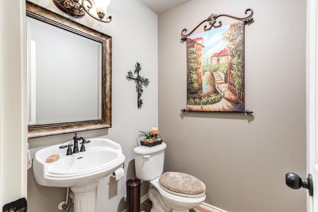 bathroom featuring sink and toilet