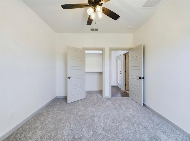 unfurnished bedroom with ceiling fan, carpet floors, and a closet
