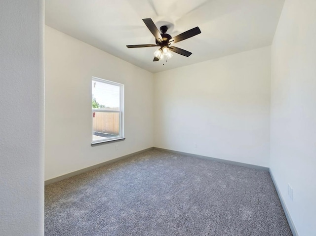 spare room featuring ceiling fan and carpet
