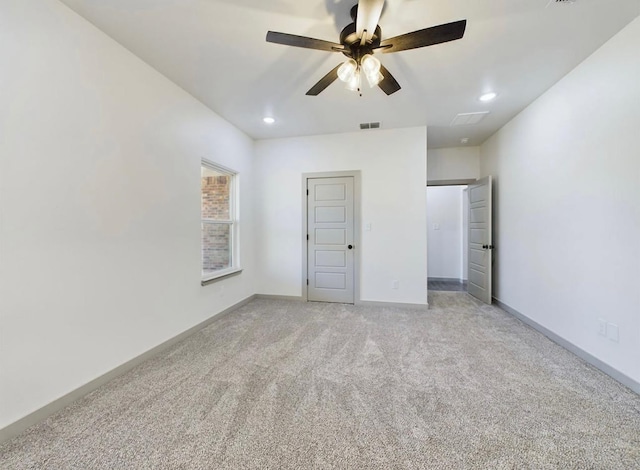 unfurnished bedroom with ceiling fan and light colored carpet