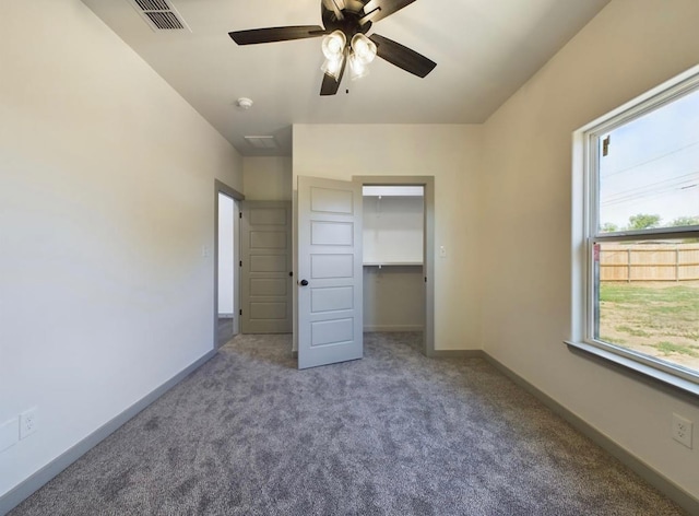 unfurnished bedroom with carpet floors, a closet, and ceiling fan