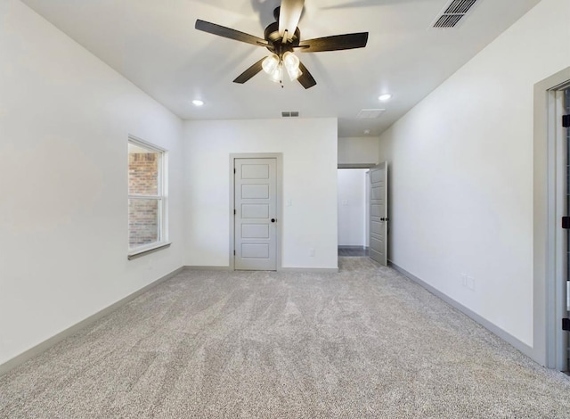 unfurnished bedroom featuring ceiling fan and light carpet