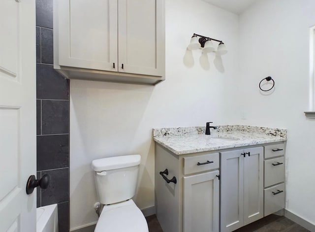 bathroom featuring vanity and toilet