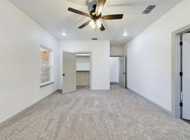 unfurnished bedroom with light colored carpet and ceiling fan