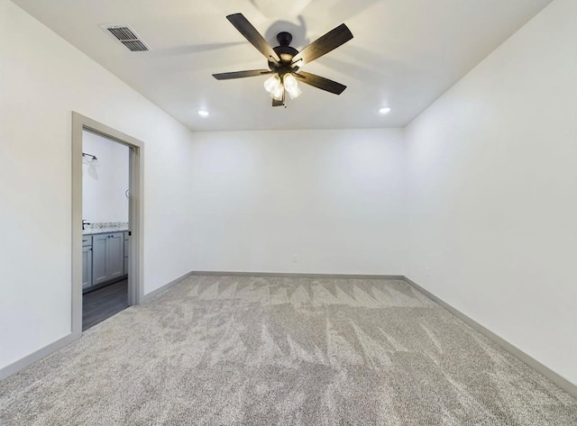 carpeted spare room featuring ceiling fan
