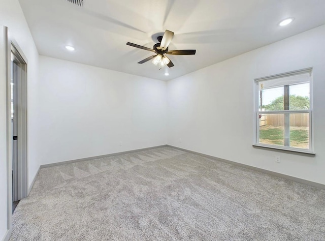 carpeted spare room with ceiling fan