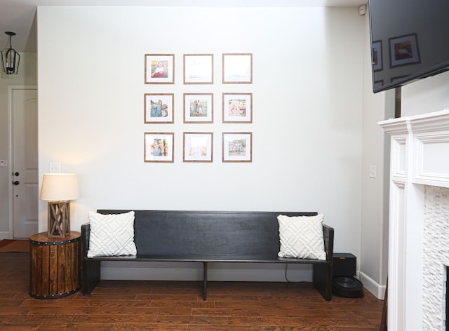 sitting room with dark wood-type flooring