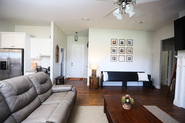 living room with ceiling fan and dark hardwood / wood-style flooring