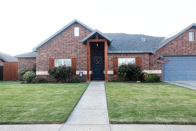 view of front facade with a garage and a front yard