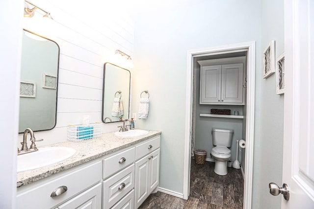 bathroom with vanity, toilet, and hardwood / wood-style floors