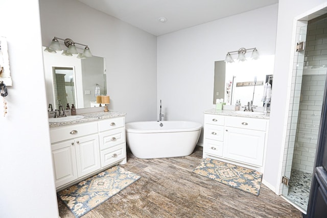 bathroom featuring independent shower and bath, vanity, and hardwood / wood-style floors