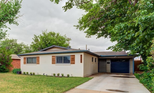 ranch-style house featuring a garage and a front yard