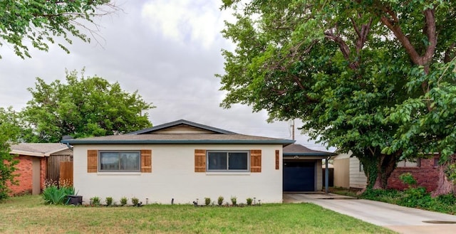 view of front of home with a garage and a front yard