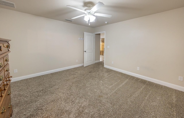 carpeted spare room with ceiling fan