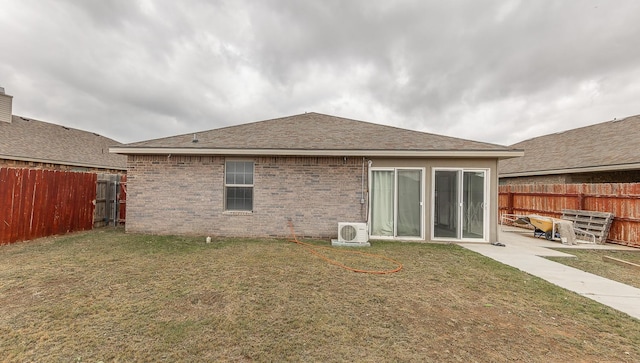 rear view of property with a yard, a patio area, and ac unit