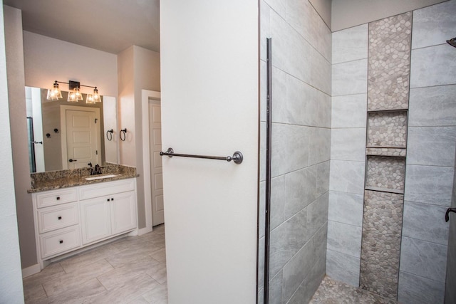 bathroom featuring vanity and tiled shower