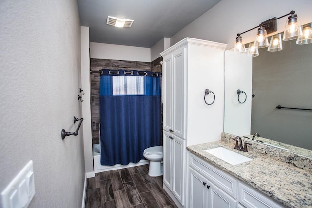 full bathroom featuring vanity, shower / tub combo, and toilet