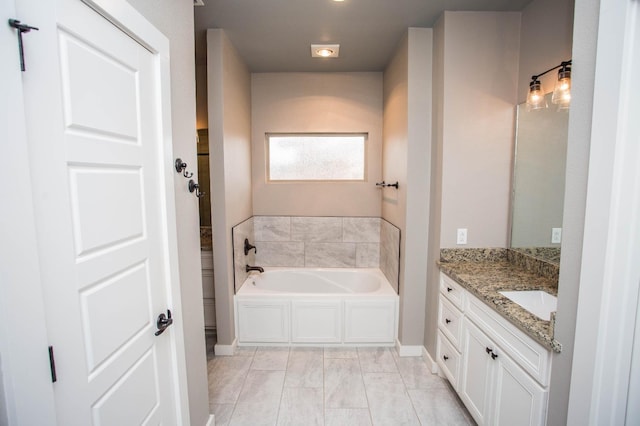 bathroom featuring a washtub and vanity