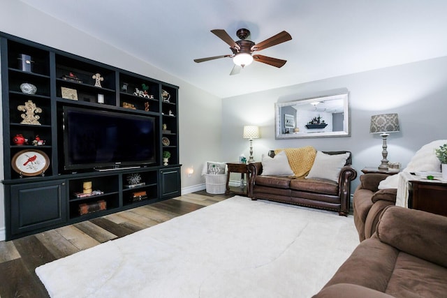 living room featuring baseboards, lofted ceiling, wood finished floors, and a ceiling fan