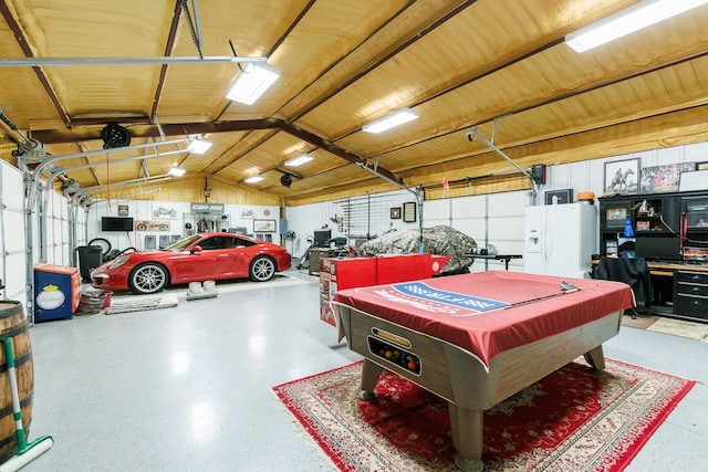 garage with white refrigerator with ice dispenser