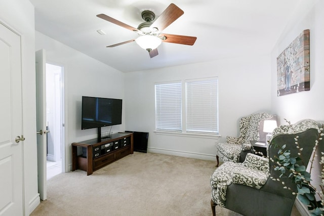 living area with carpet flooring, baseboards, and ceiling fan