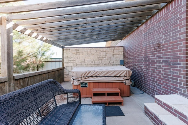 view of patio / terrace with an outdoor living space, a hot tub, and a pergola