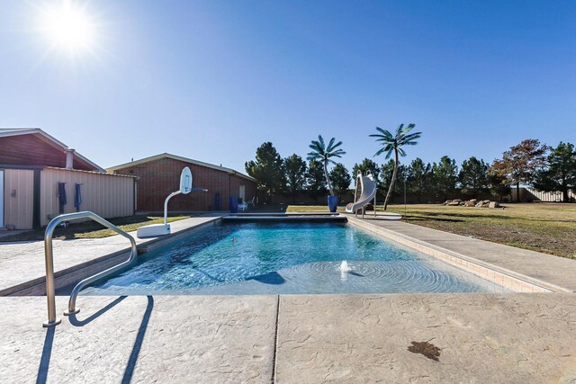 pool with a lawn and a water slide