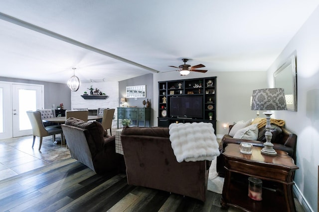 living room with dark wood-style flooring and ceiling fan with notable chandelier