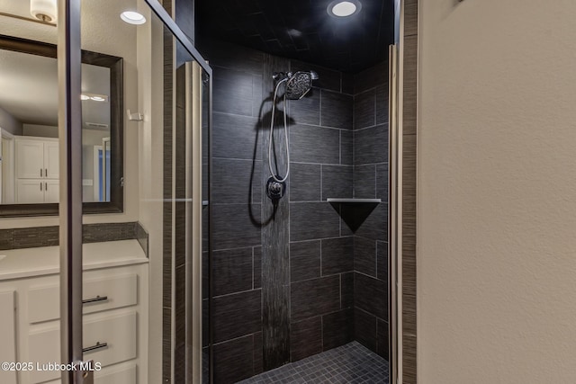 4020 125th St, Lubbock, TX 79423 - full bathroom featuring a stall shower, a textured wall, and vanity