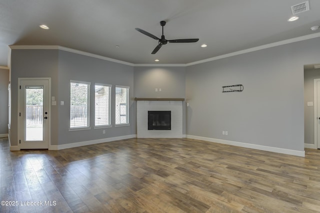 4020 125th St, Lubbock, TX 79423 - unfurnished living room featuring a ceiling fan, wood finished floors, crown molding, recessed lighting, and a glass covered fireplace