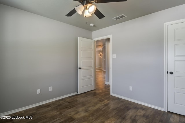 4020 125th St, Lubbock, TX 79423 - unfurnished bedroom with dark wood-type flooring, a chandelier, and a ceiling fan
