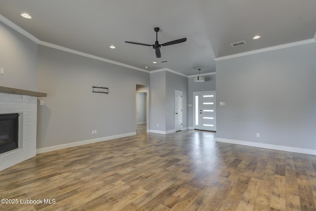 4020 125th St, Lubbock, TX 79423 - unfurnished living room featuring a ceiling fan, wood finished floors, recessed lighting, a brick fireplace, and ornamental molding