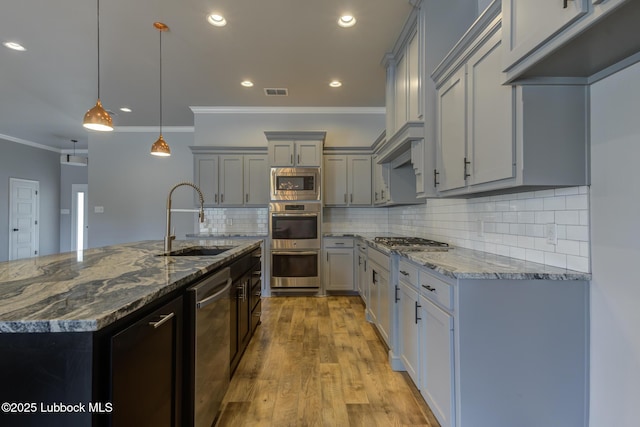 4020 125th St, Lubbock, TX 79423 - kitchen with stainless steel appliances, gray cabinets, stone counters, crown molding, and recessed lighting