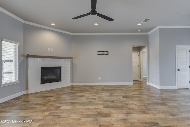 4020 125th St, Lubbock, TX 79423 - unfurnished living room with crown molding, a ceiling fan, a fireplace, wood finished floors, and recessed lighting