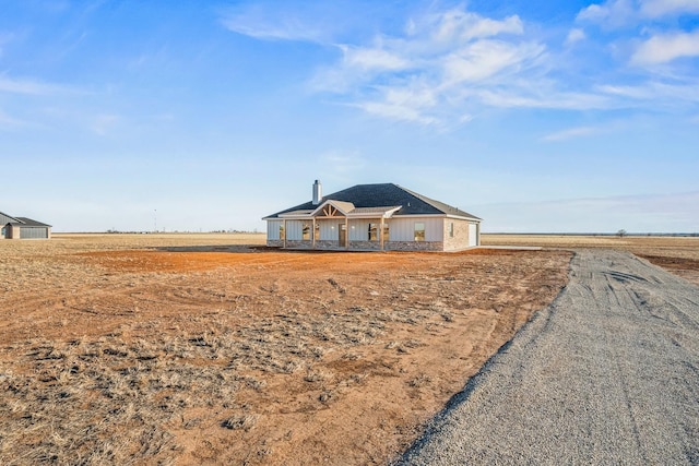 exterior space featuring a rural view and covered porch