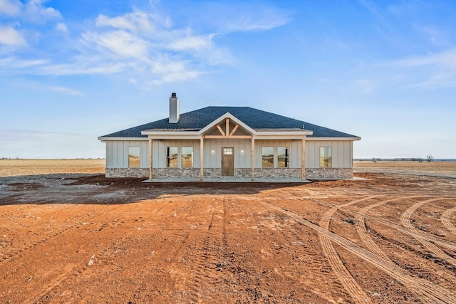 view of front of home with french doors and a rural view