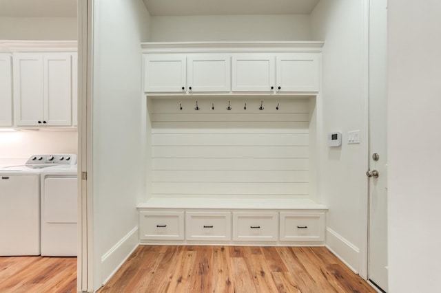 mudroom featuring separate washer and dryer and light hardwood / wood-style flooring